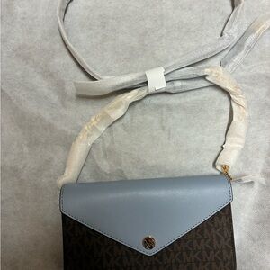 Michael Kors Blue and Brown Jet Set Travel clutch with strap.